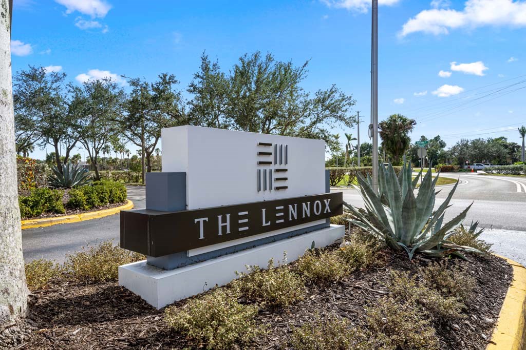 a monument sign for the lenox on the side of a road