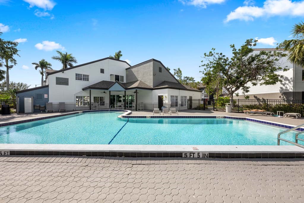 a large swimming pool with a building in the background