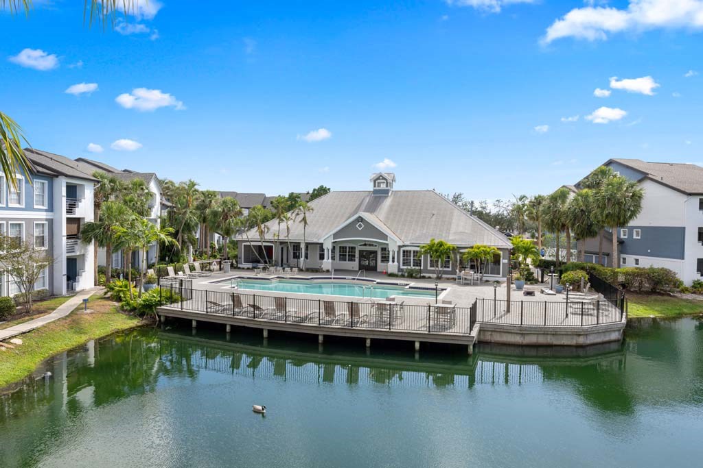a large pool in front of a building on a body of water