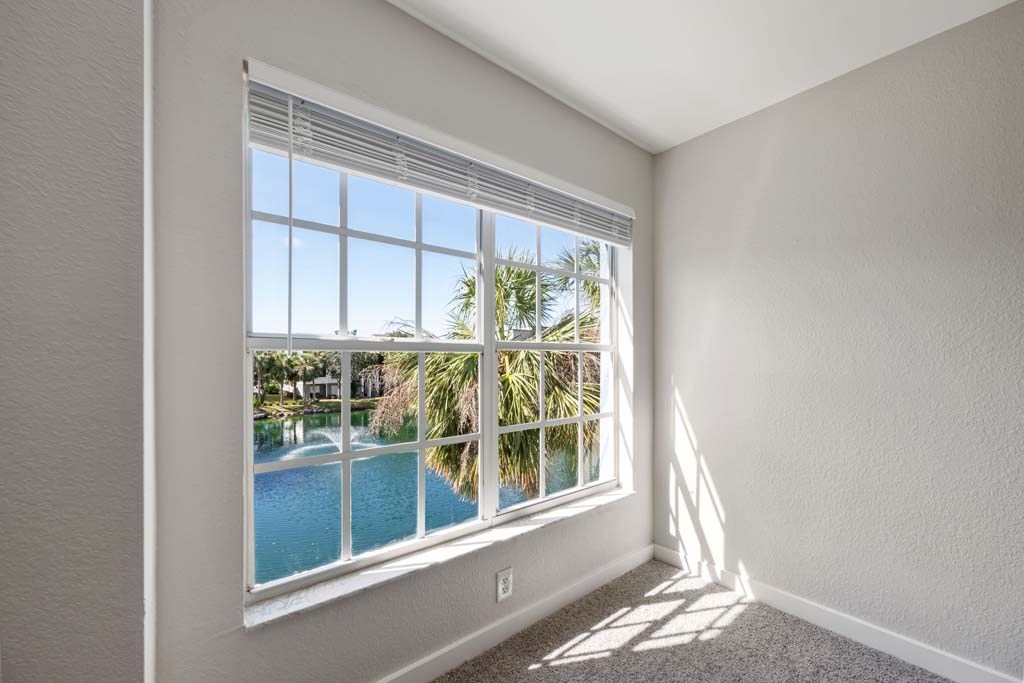 a room with a large window overlooking a swimming pool