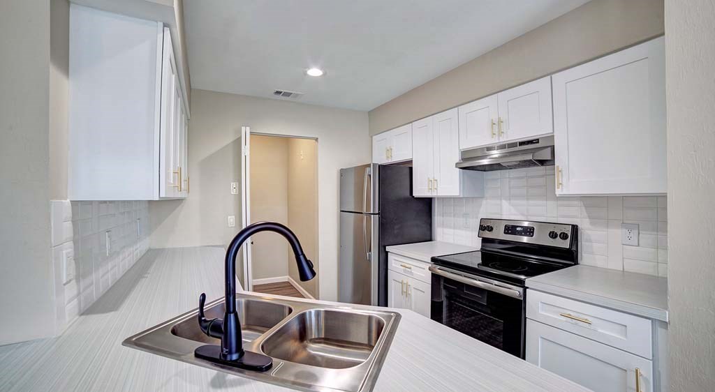 a kitchen with a sink and a stove