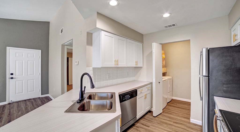 a kitchen with a sink and a refrigerator