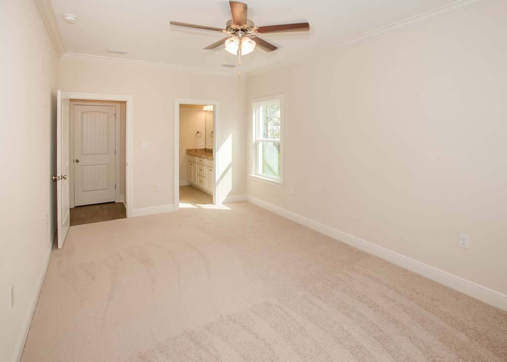 an empty living room with a ceiling fan