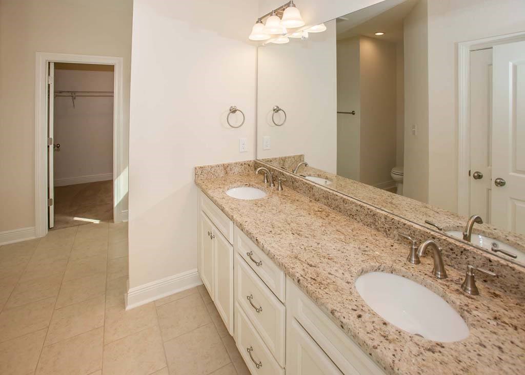 a bathroom with two sinks and a large mirror
