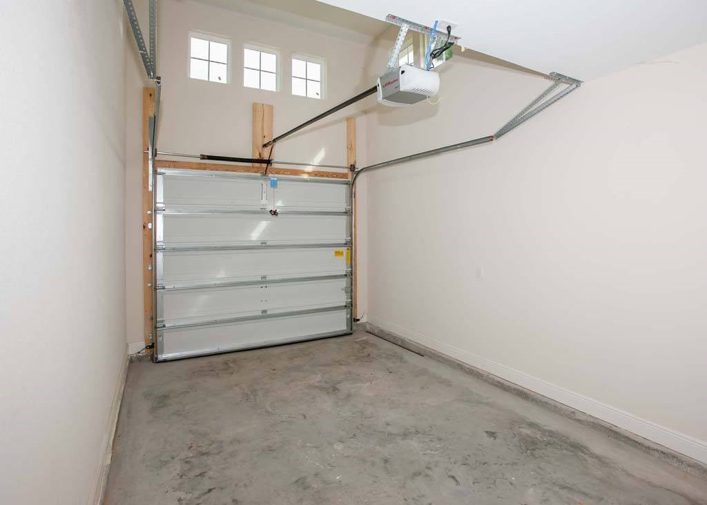 a garage with white walls and a clear garage door