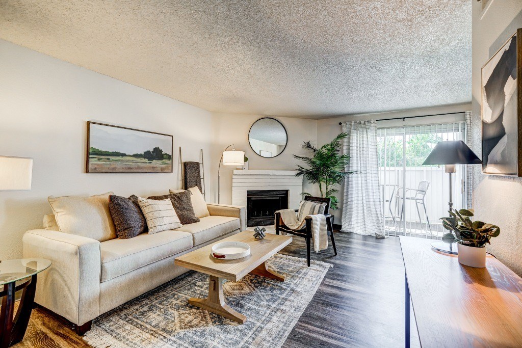 a living room with a couch and a coffee table and a fireplace