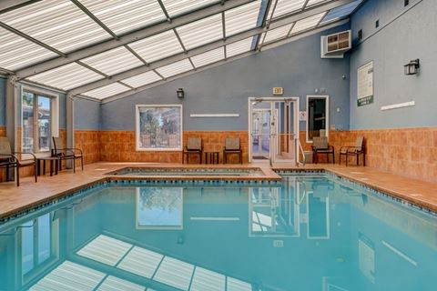 a swimming pool under a glass ceiling in a hotel room