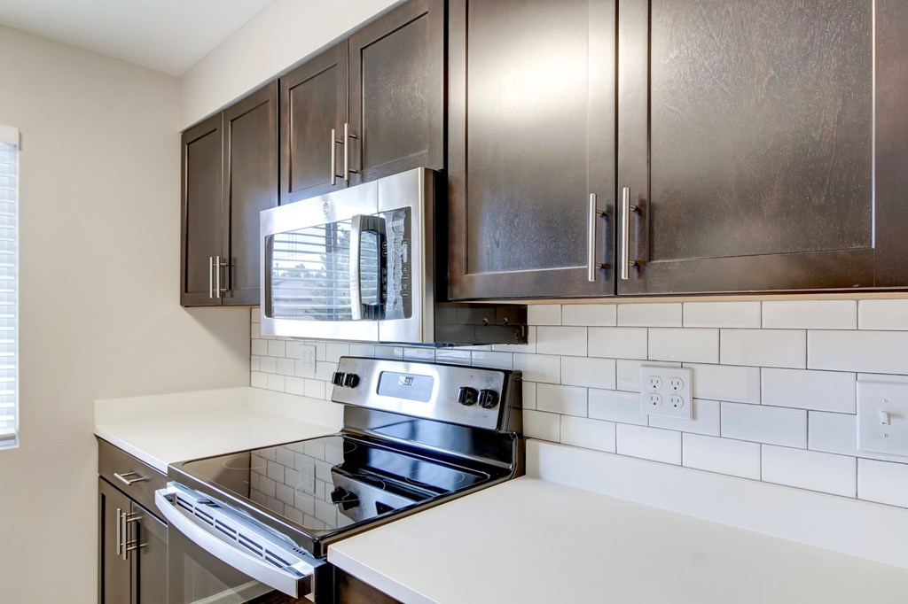 a kitchen with stainless steel appliances and wooden cabinets