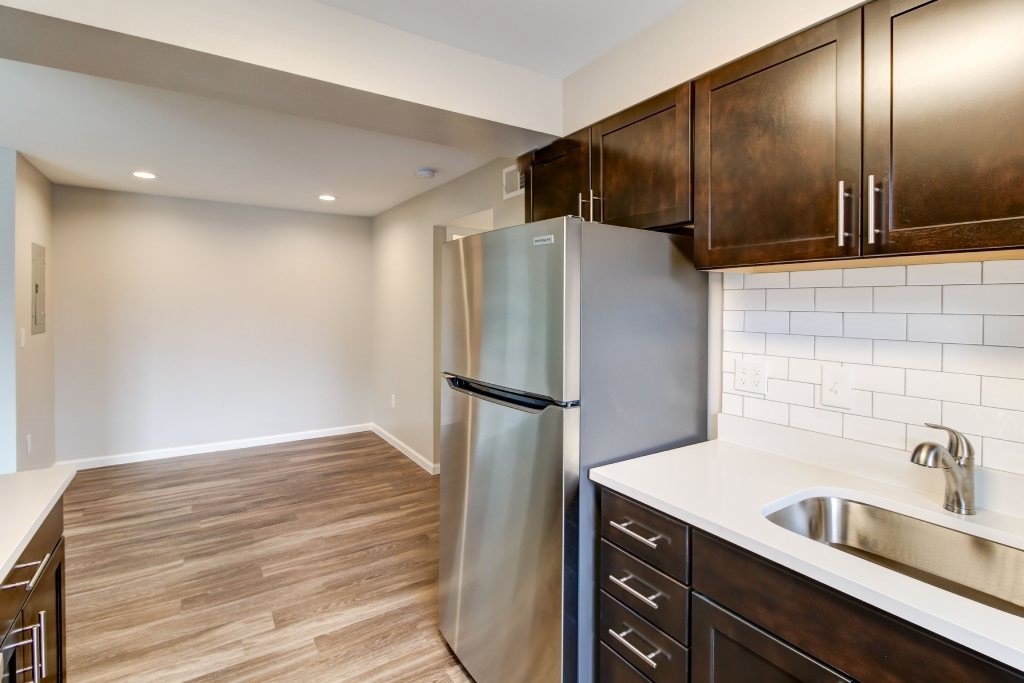 a kitchen with stainless steel appliances and wooden cabinets