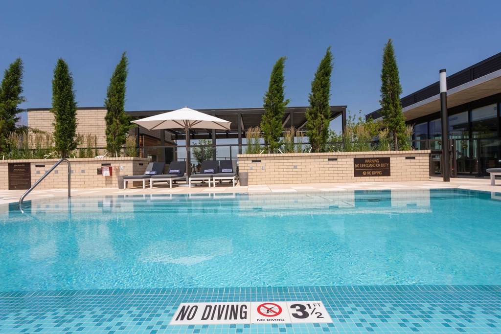 a swimming pool at a hotel with a no diving sign