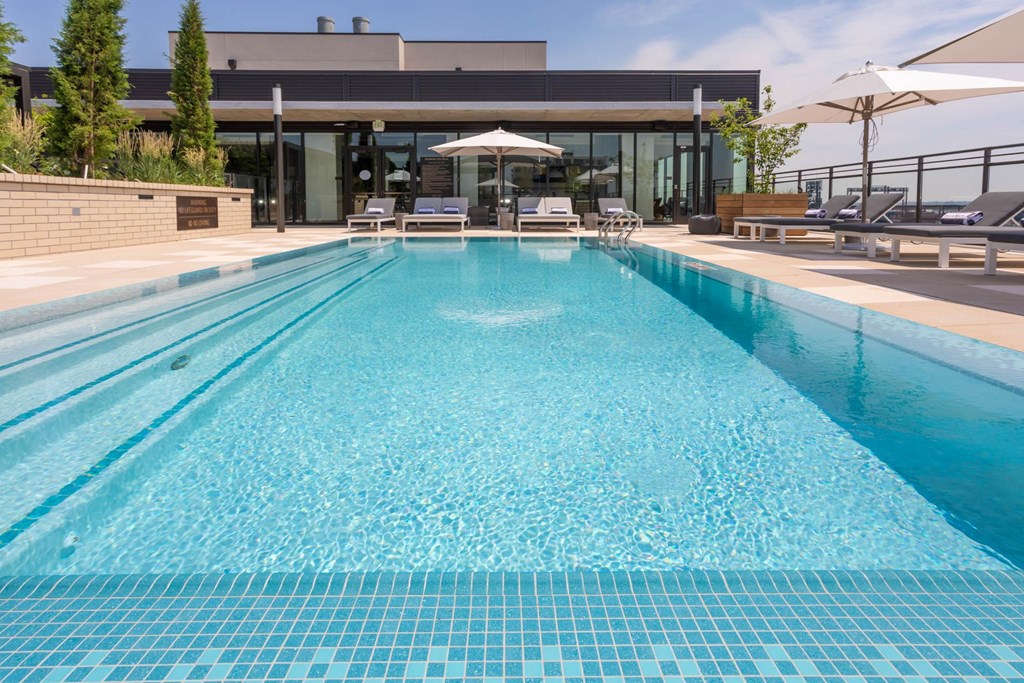 a swimming pool with a building in the background