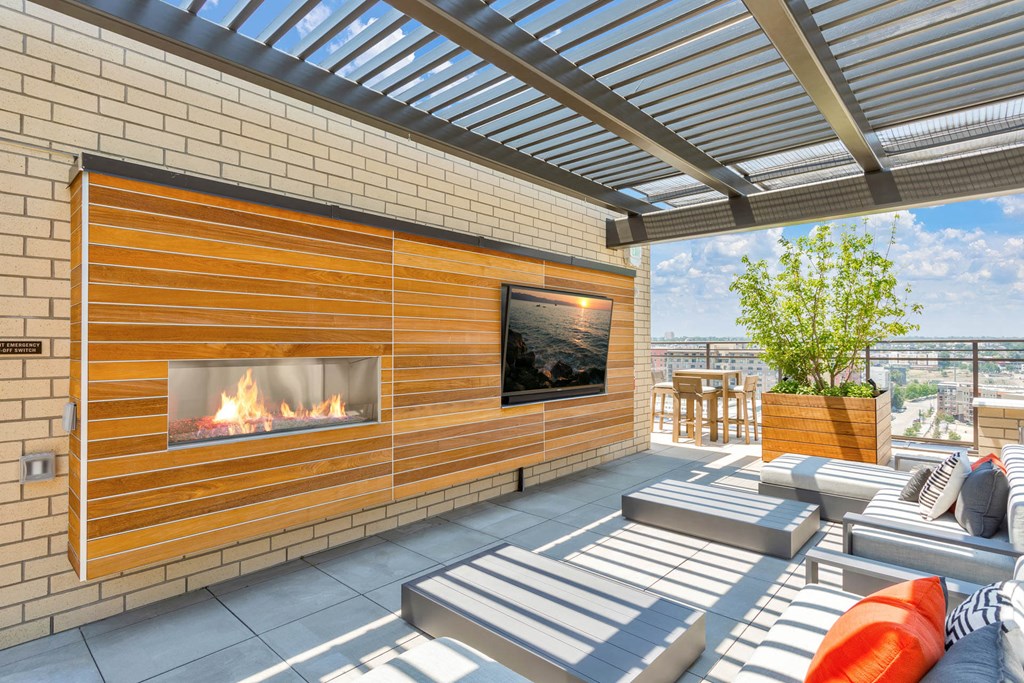 a patio with couches and a fireplace