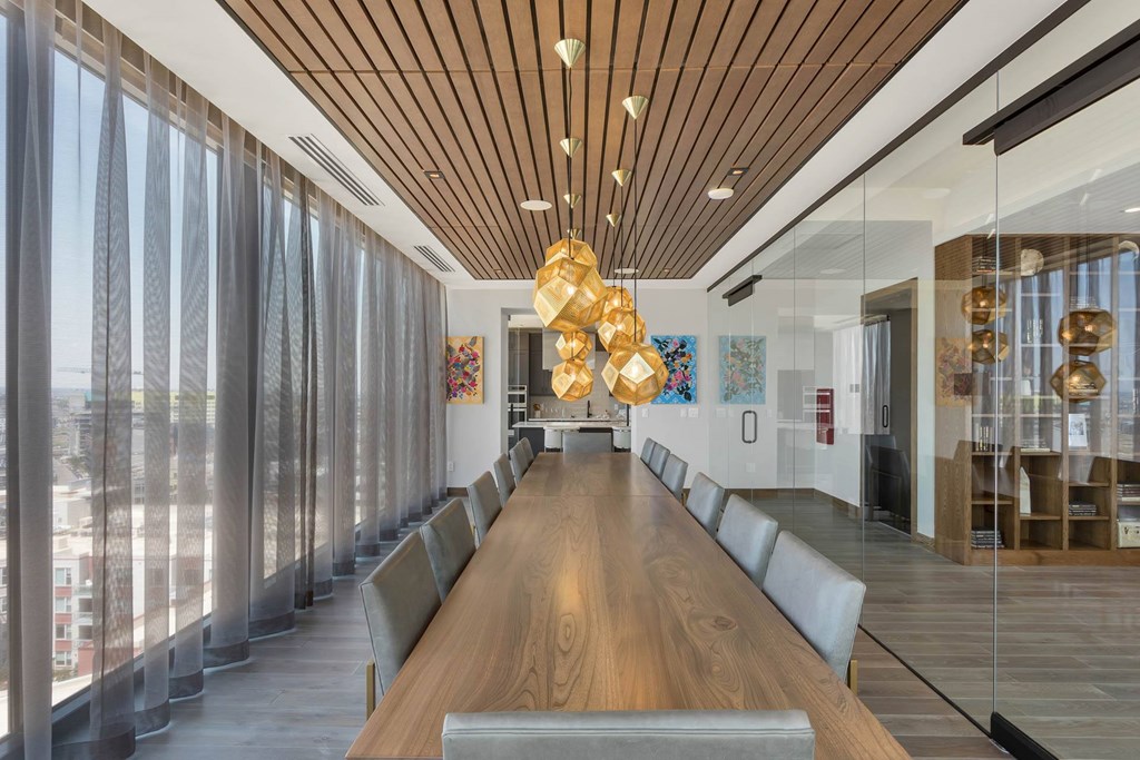 a large conference room with a long wooden table and chairs