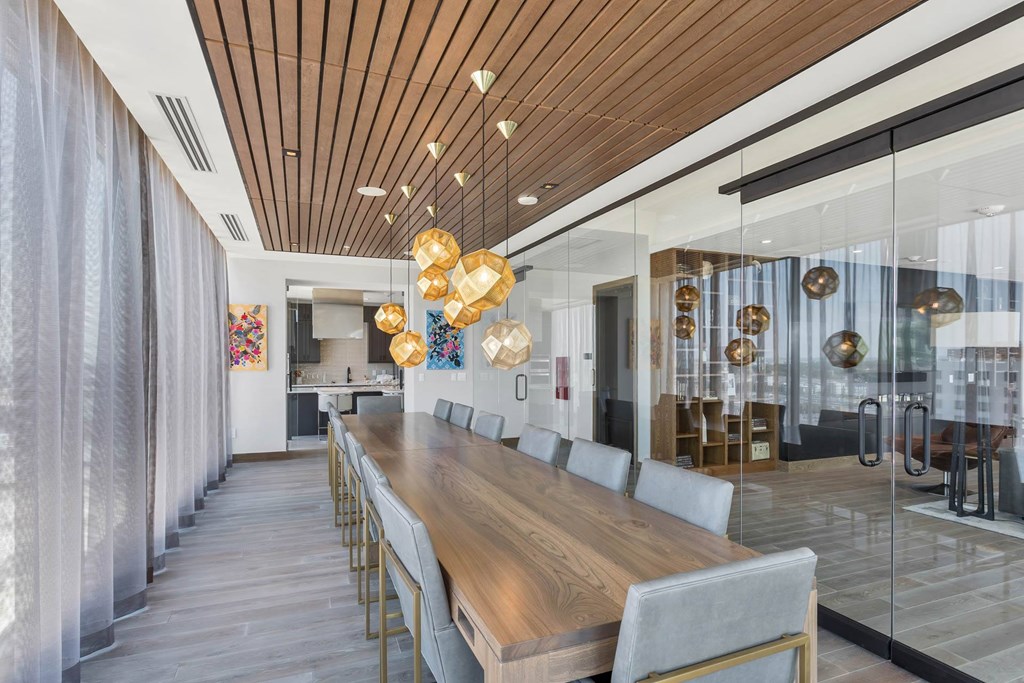 a long dining room with a long wooden table and chairs
