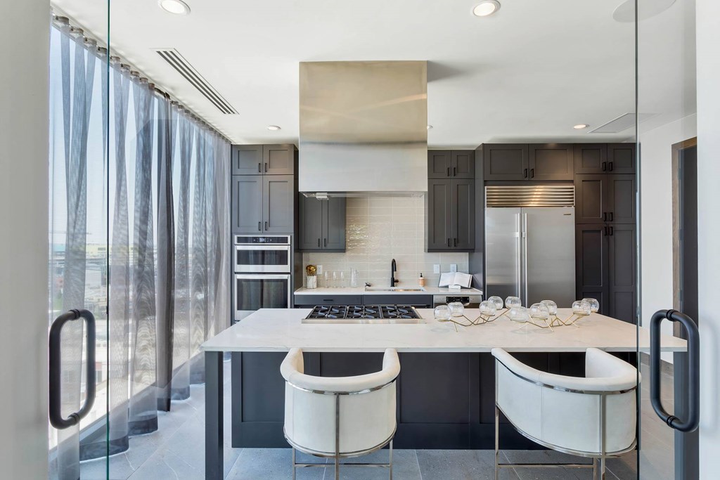 a kitchen with a marble counter top and stainless steel appliances
