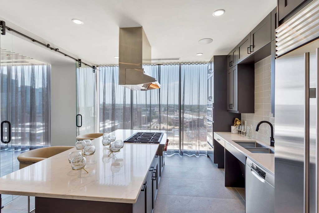 a kitchen with a long counter and a large window