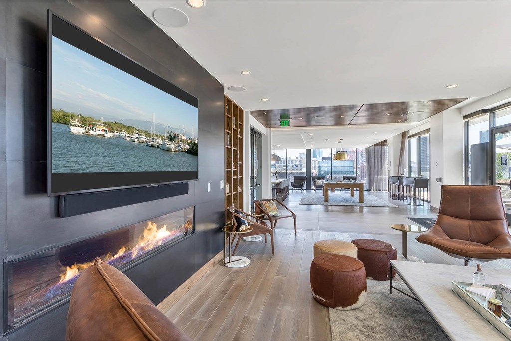 a living room with a fireplace and a tv on the wall