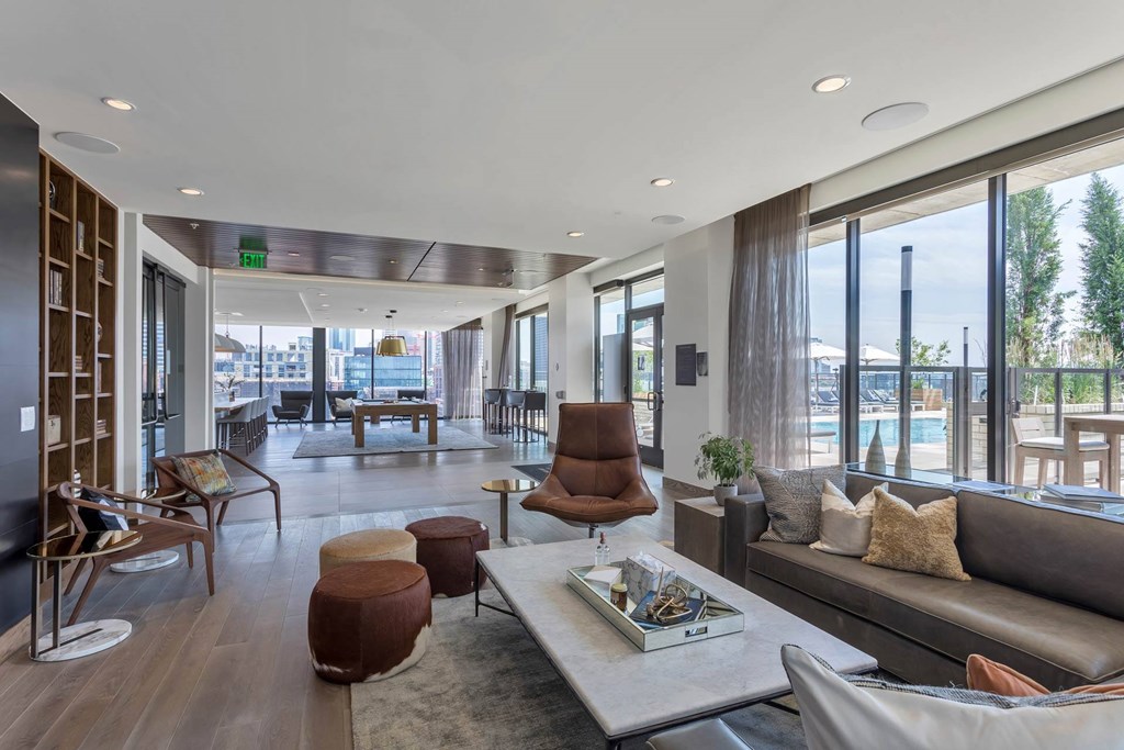 the living room has a view of the harbor and the pool