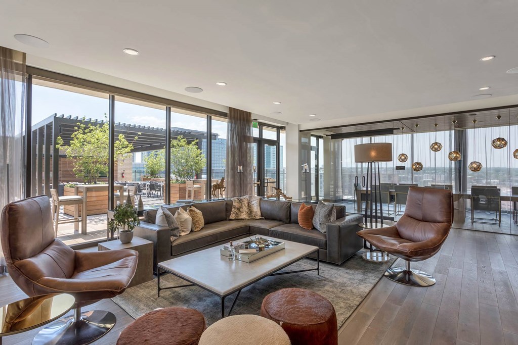 a living room with leather furniture and large windows