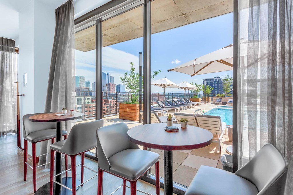a rendering of a balcony with tables and chairs and a pool