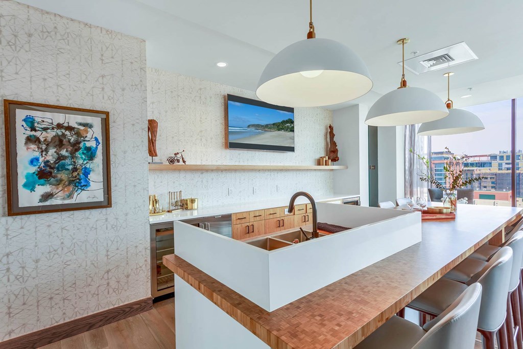 a kitchen with a long counter top and a sink