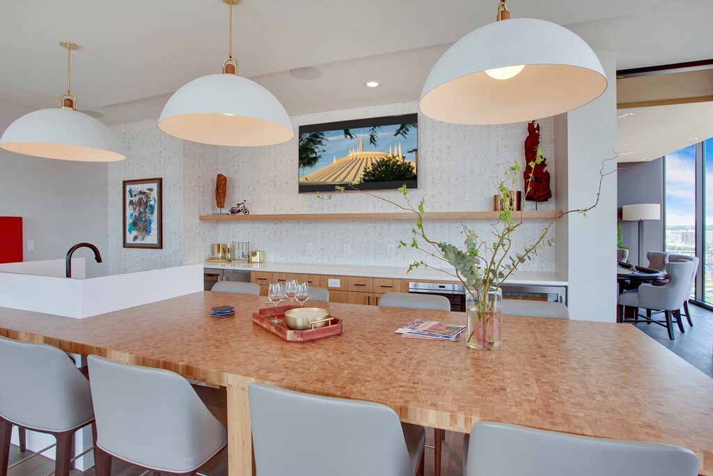 a large kitchen with a wooden table and chairs