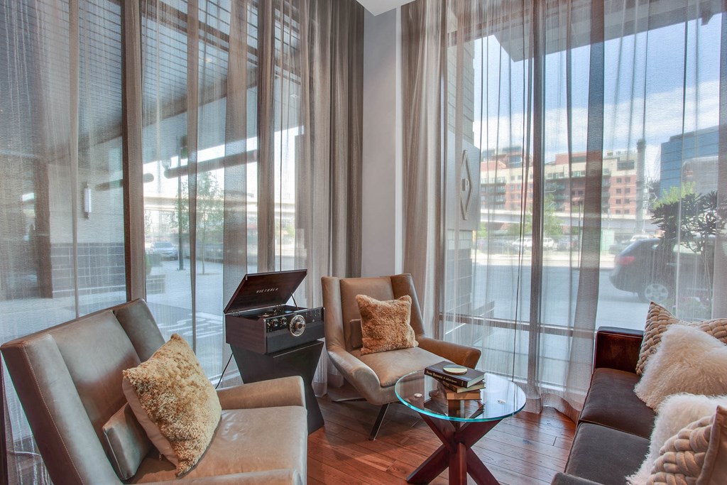 a living room with a couch and chairs and a record player