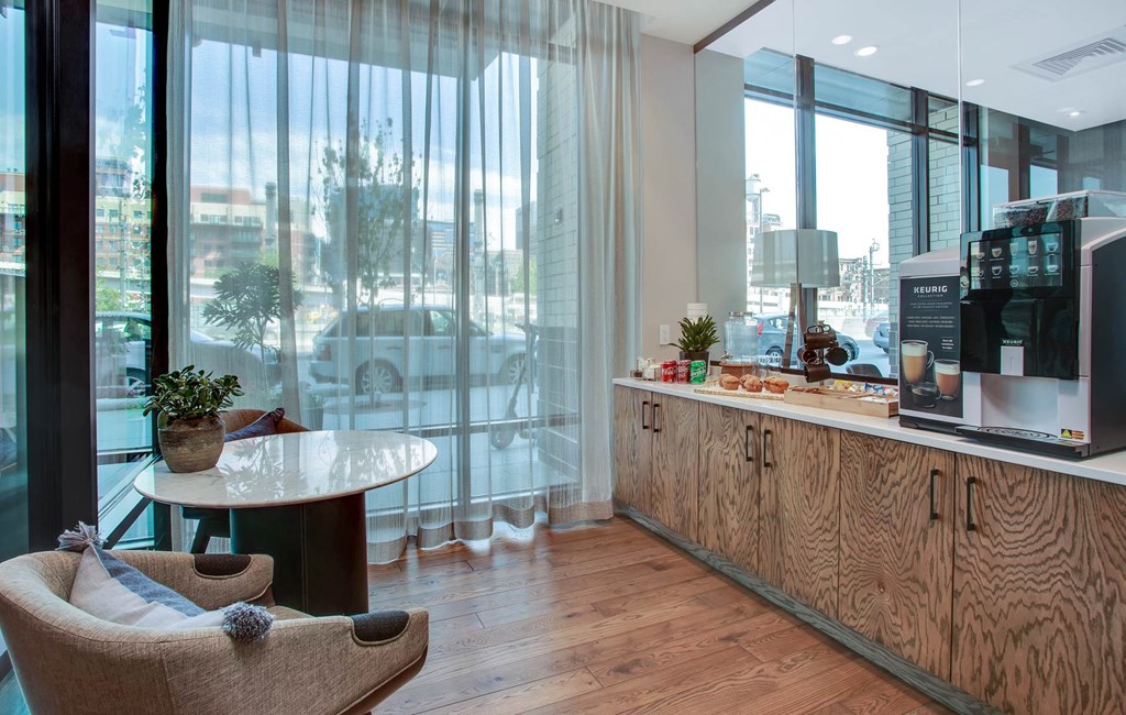 a hotel lobby with a coffee bar and a view of the city
