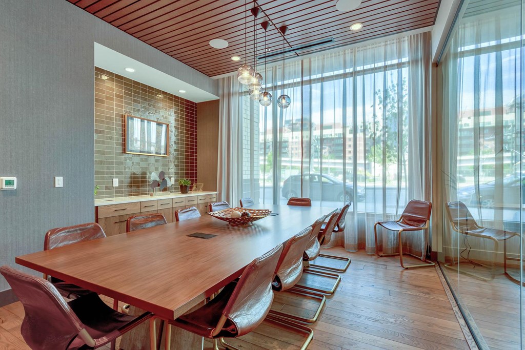 a dining room with a long wooden table and chairs