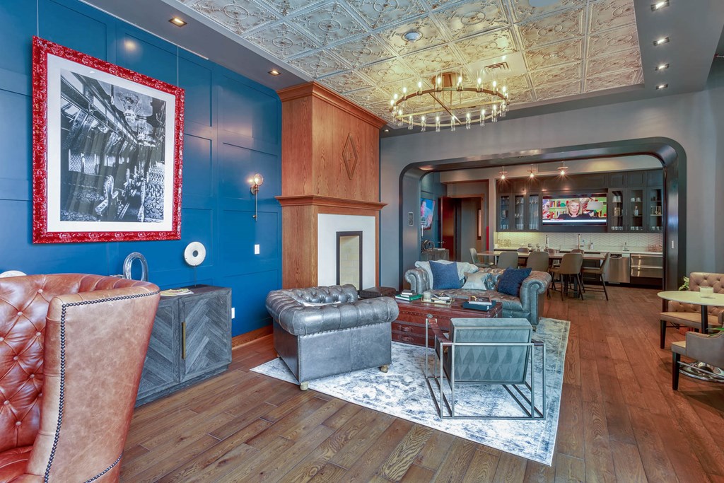 a living room with blue walls and leather furniture