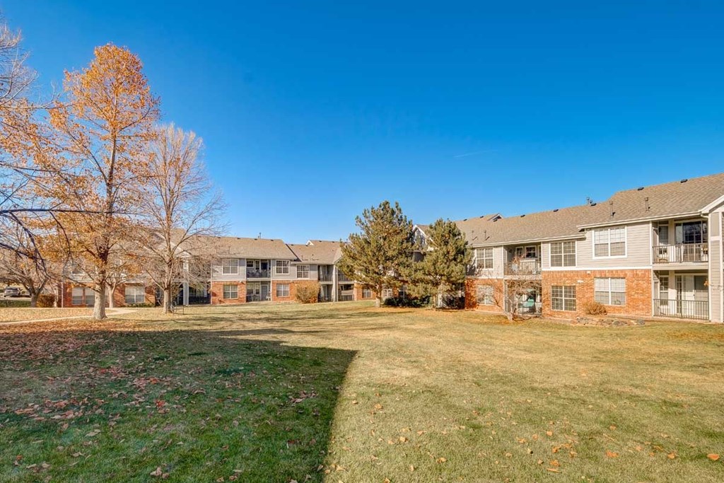 a large yard in front of some apartment buildings