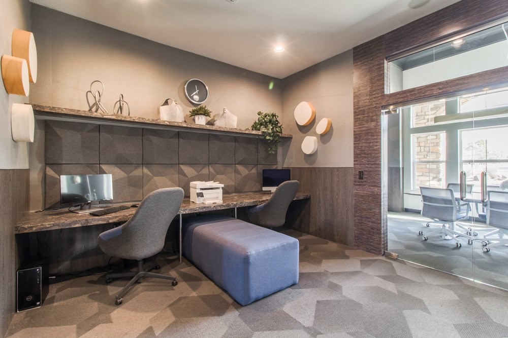 a lobby with two chairs and a desk and a window