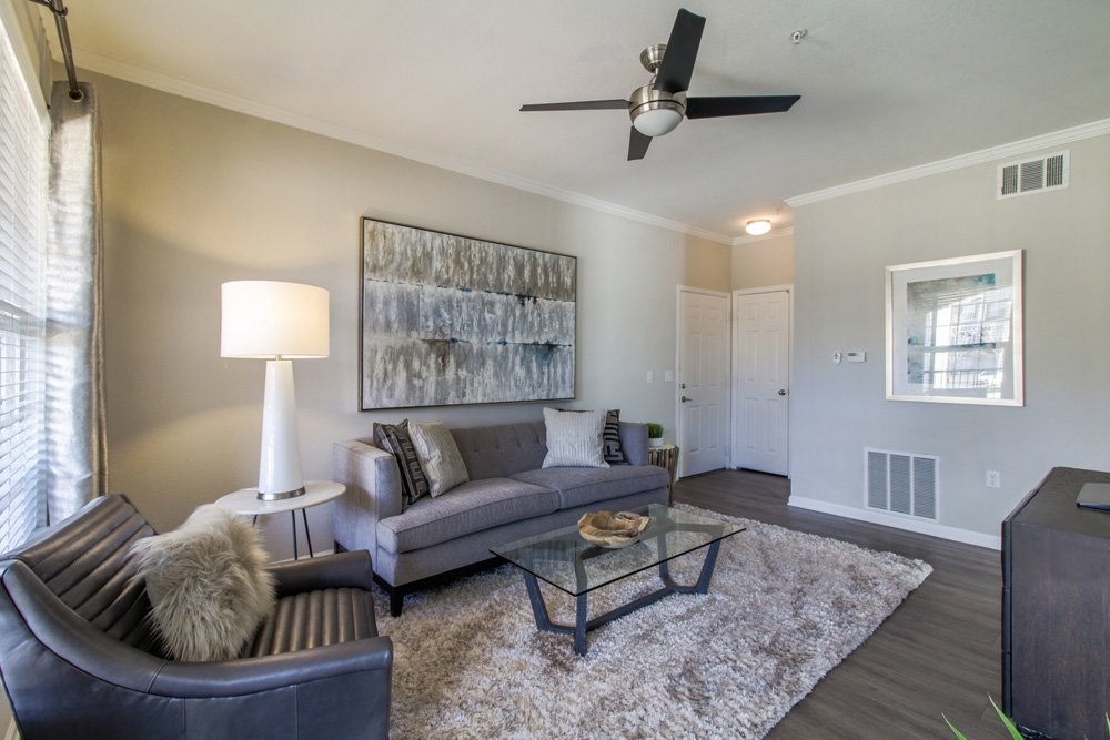 a living room with a couch and a ceiling fan