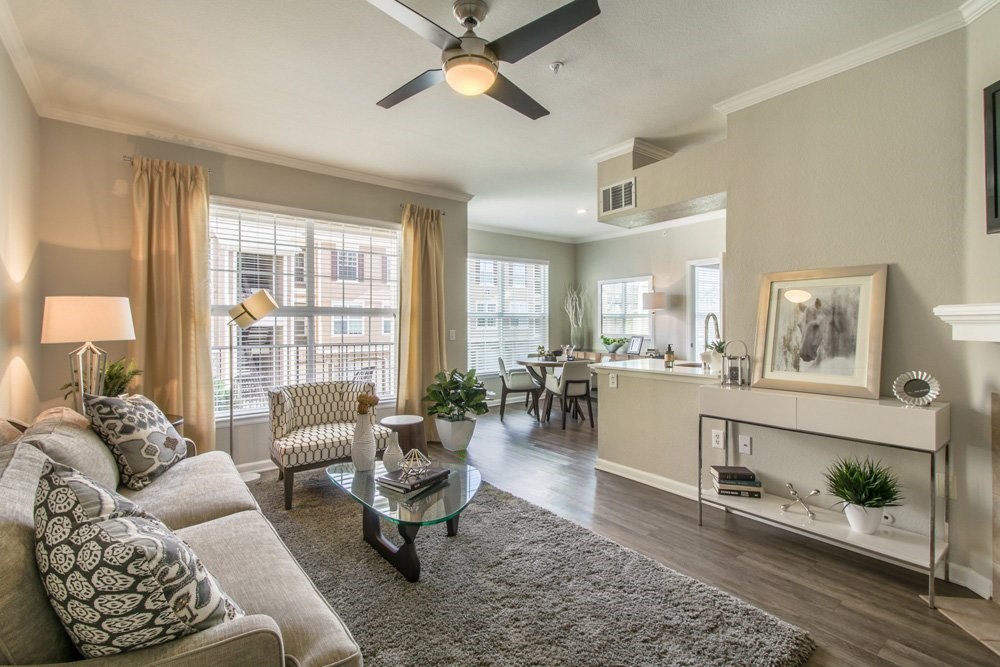 a living room with a couch and a ceiling fan
