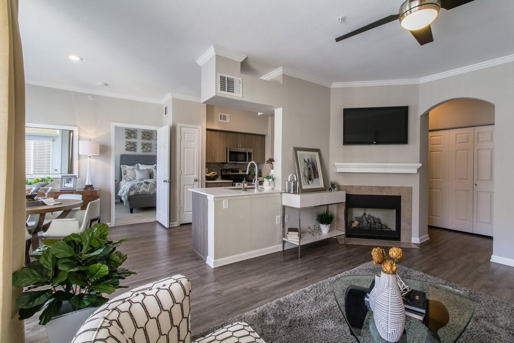 a living room with a fireplace and a kitchen
