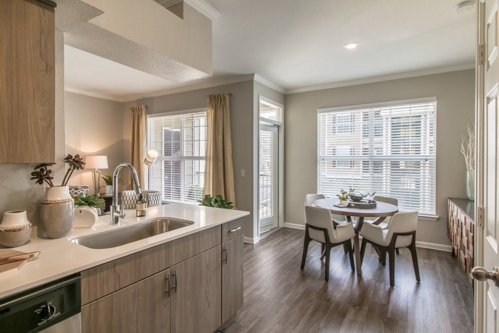 an open kitchen and dining room with a table and chairs