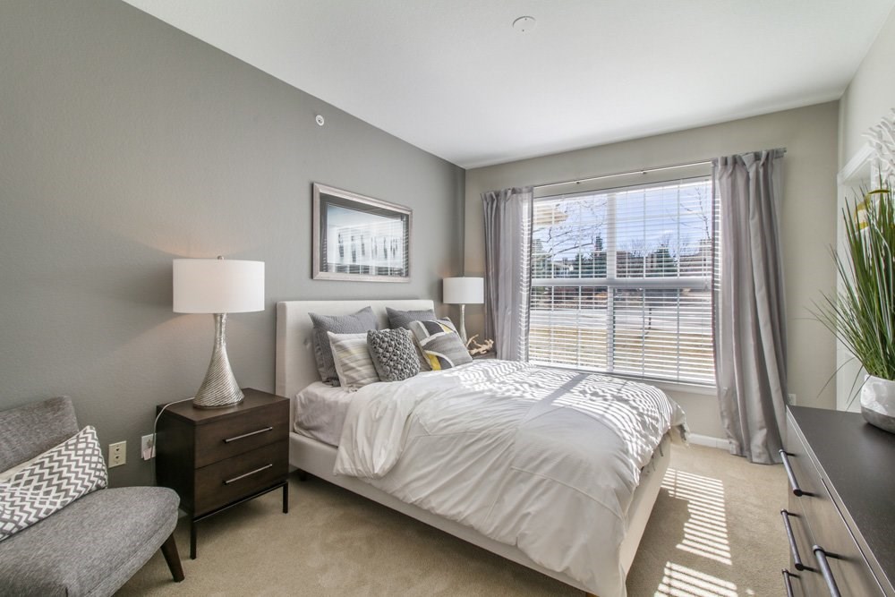 a bedroom with a large bed and a window