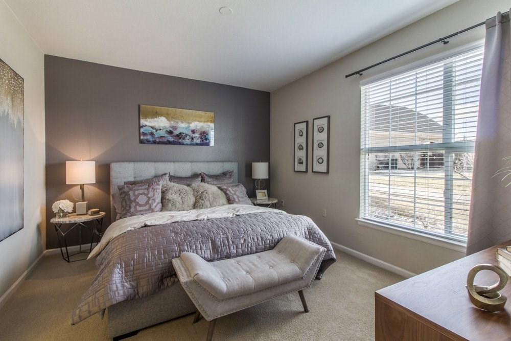 a bedroom with a large bed and a window