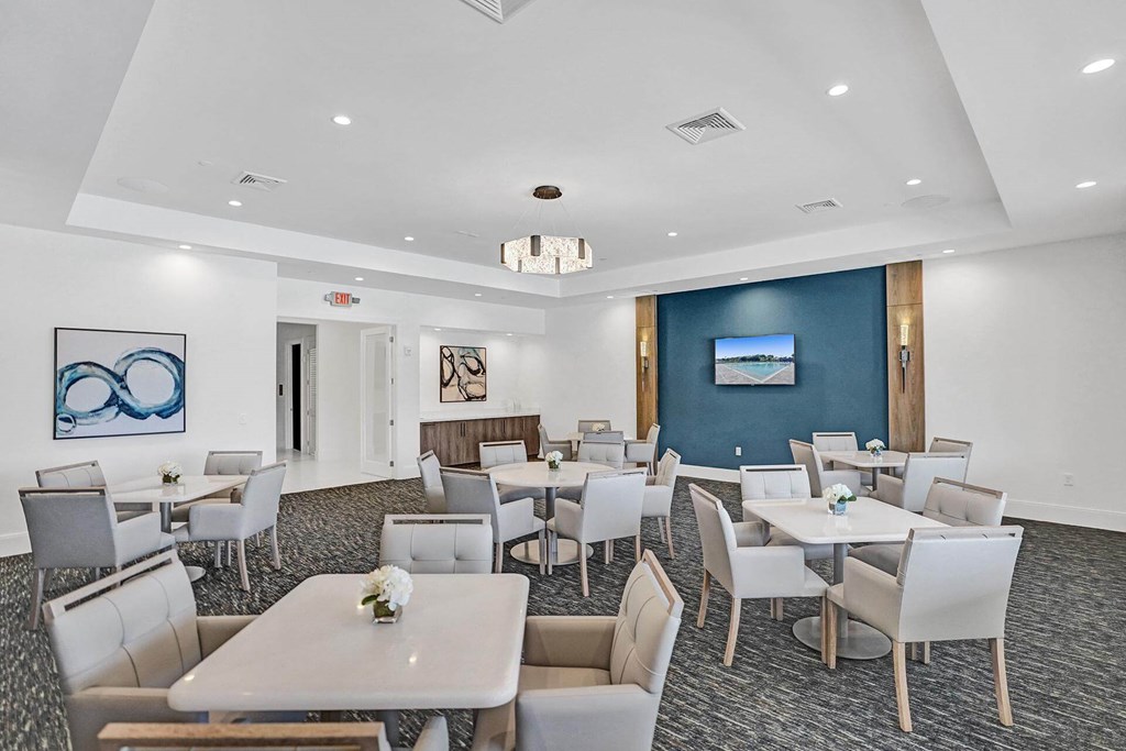 a conference room with tables and chairs and a blue wall