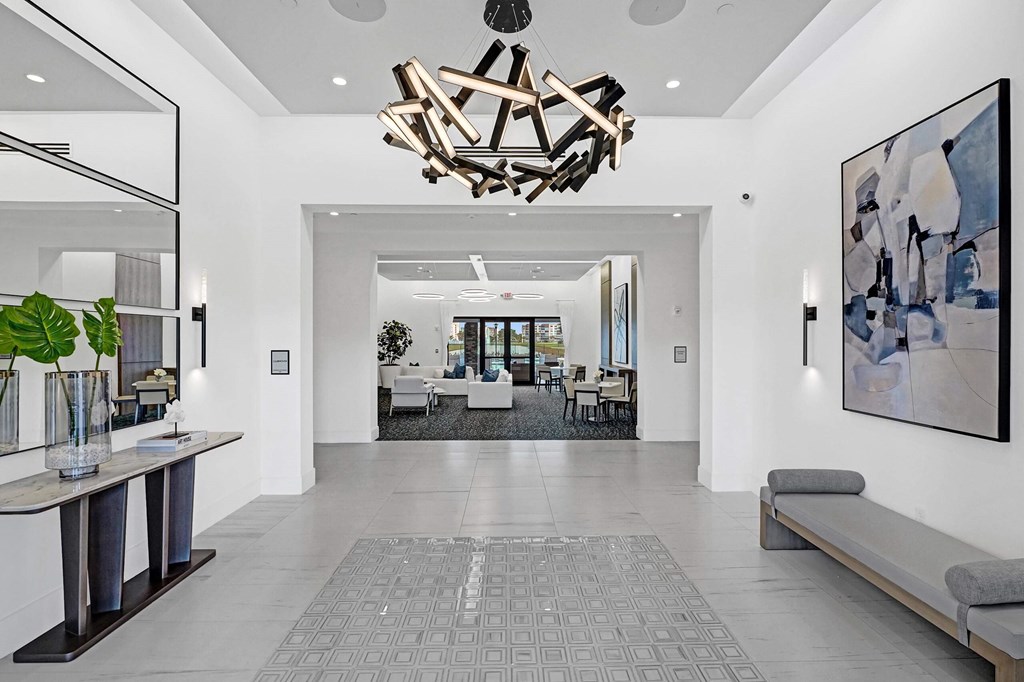 the living room has a large chandelier and a view of the dining room