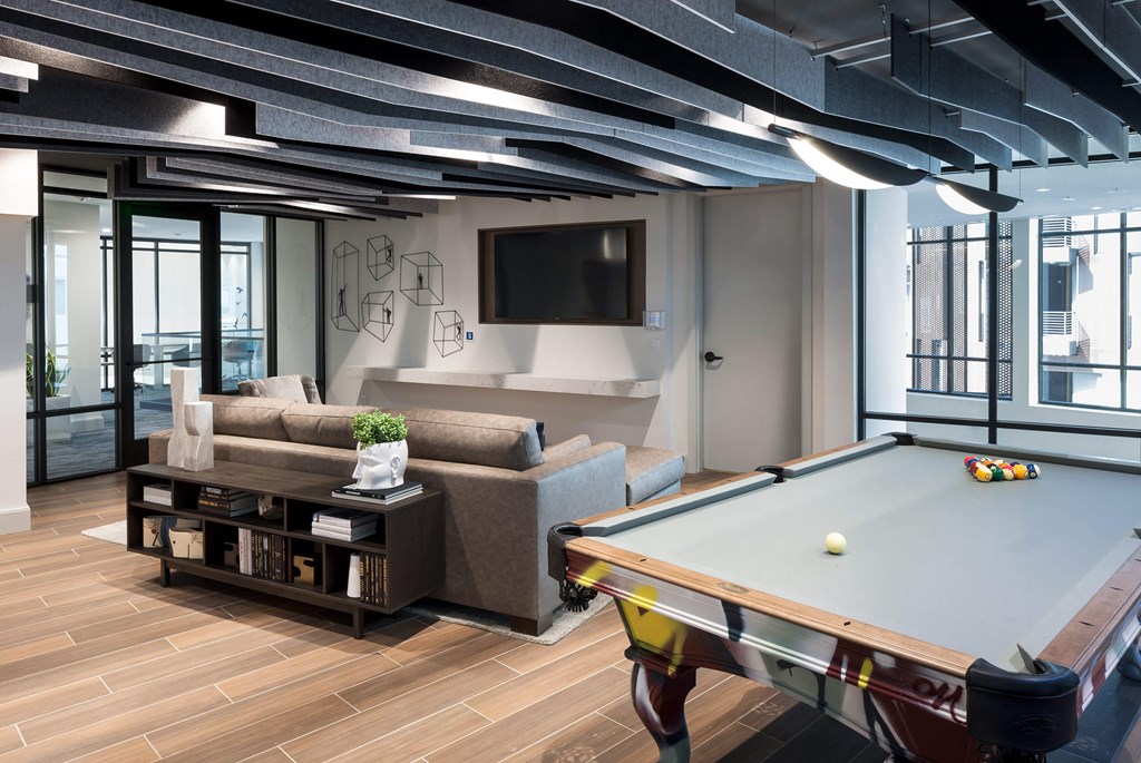 a games room with a pool table and a television