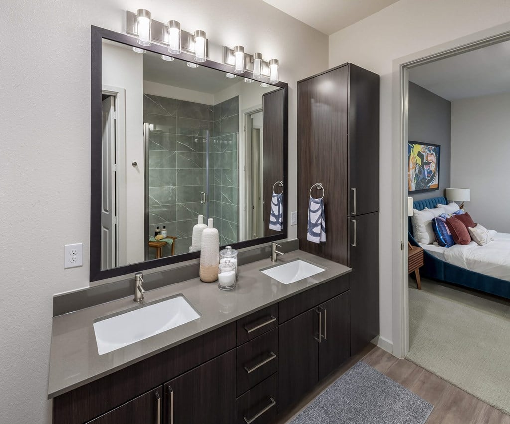 a bathroom with two sinks and a large mirror