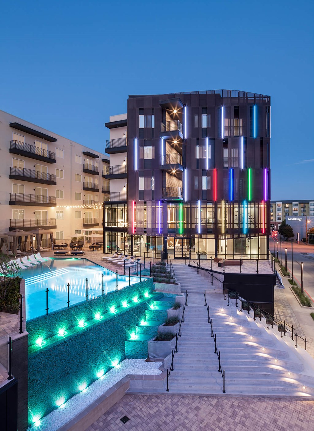 a hotel with a swimming pool at night
