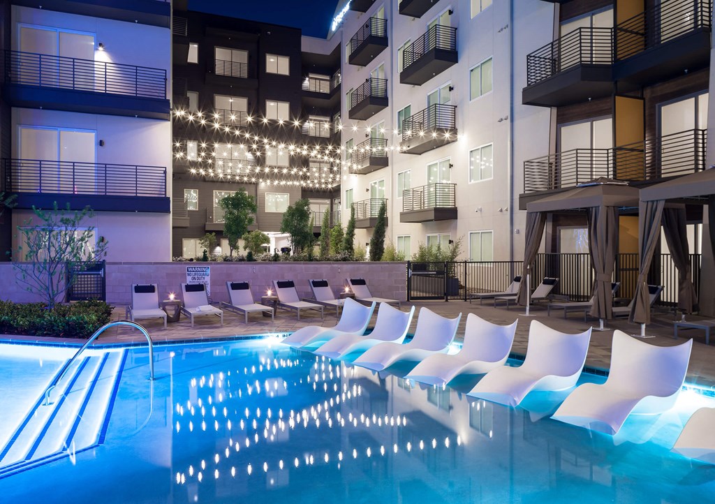 a swimming pool in an apartment building at night