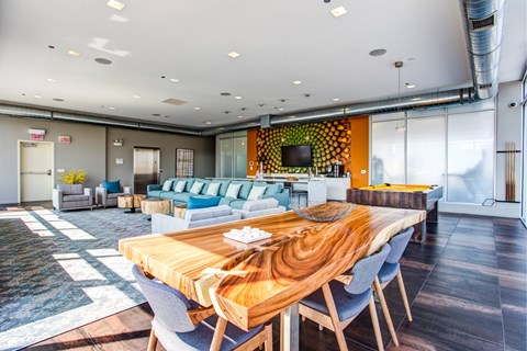 A modern dining room with a wooden table and chairs.