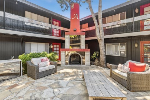 A patio area with a fireplace and seating area.