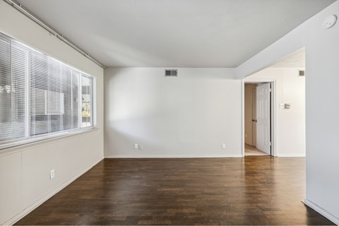 A room with wooden floors and white walls.