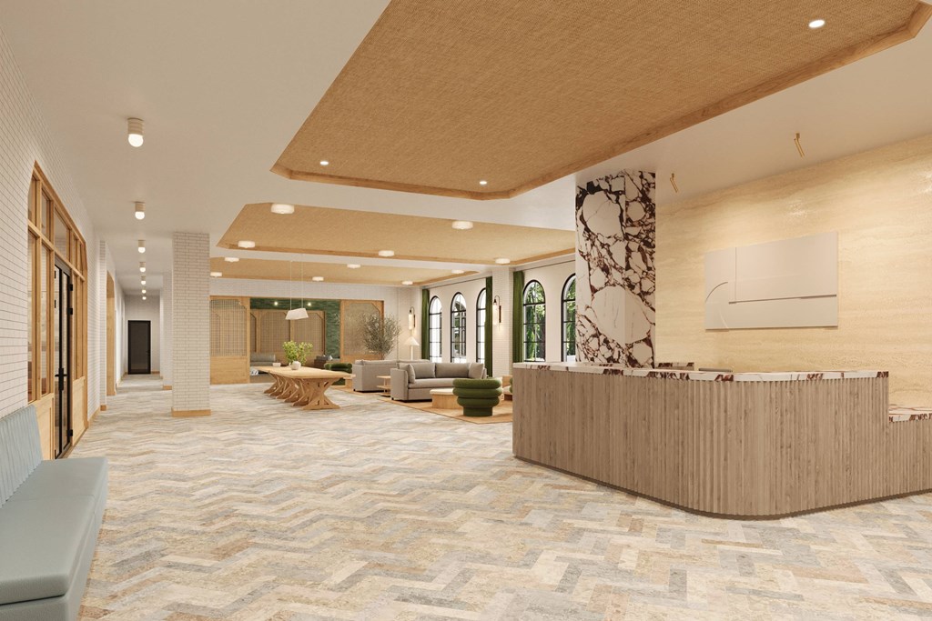 a lobby with a reception desk and a marble floor
