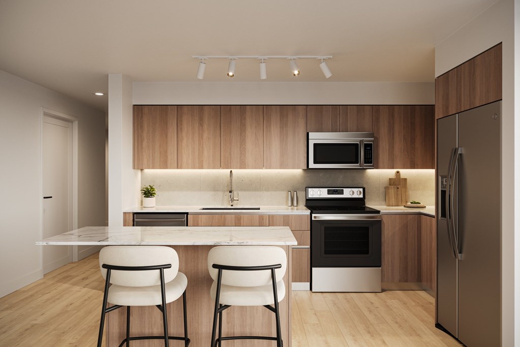 a kitchen with wooden cabinets and a white island with three stools