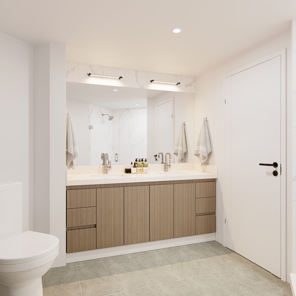 a bathroom with a toilet sink and a mirror